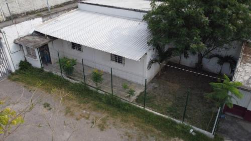 a white house with a fence in front of it at Villas La Vista in Tuxpan de Rodríguez Cano