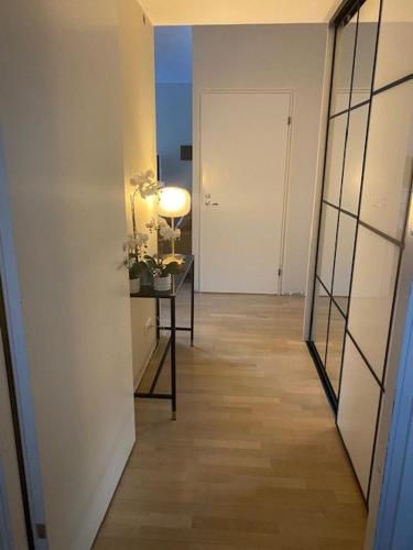 a hallway with a room with a table and a door at Lovely 1-bedroom apartment with patio and sauna in Tampere