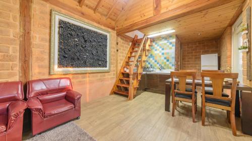 a room with a table and chairs and a ladder at Gapyeong ebenzer Pension in Gapyeong