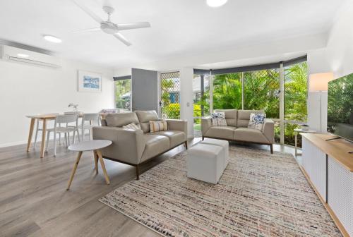 a living room with a couch and a table at 2 Bedroom Villa In Tropical Resort in Noosaville