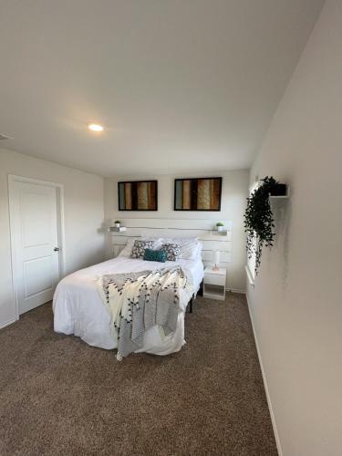 a bedroom with two beds with white sheets at Spacious 4-Bedroom Retreat with High-Speed WiFi and Tranquil Ambiance in Aubrey
