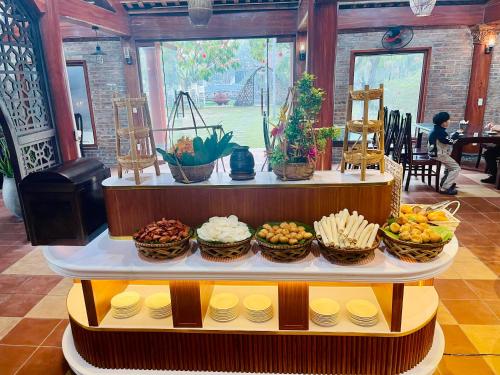 a display of food on a table in a restaurant at Hoa Lu Garden Resort in Ninh Binh