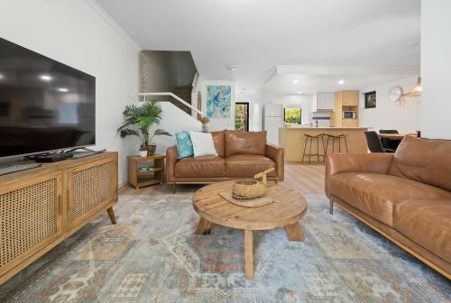 a living room with a couch and a coffee table at Modern & Stylish 2 Bedroom Townhouse in Noosaville