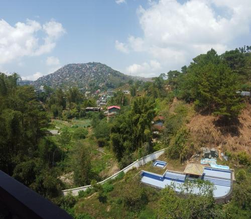 a view of a hill with houses and trees at The Courtyards Goshen in Baguio