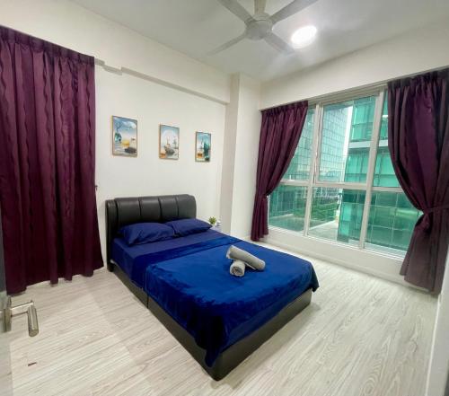 a bedroom with a blue bed with purple curtains at Sutera Avenue Homestay , Opposite Imago , Kota Kinabalu in Kota Kinabalu
