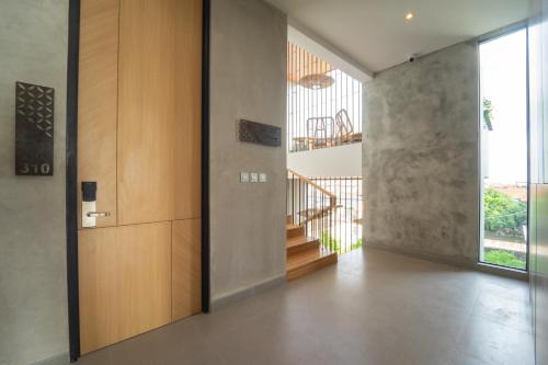 a hallway with a staircase in a house at Keenan Living Luxe Seturan in Seturan