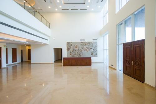 a large white room with a large painting on the wall at Eternal Oasis by Alaya Stays, Golf Course Road in Gurgaon