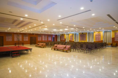 a large room with ping pong tables and chairs at Eternal Oasis by Alaya Stays, Golf Course Road in Gurgaon