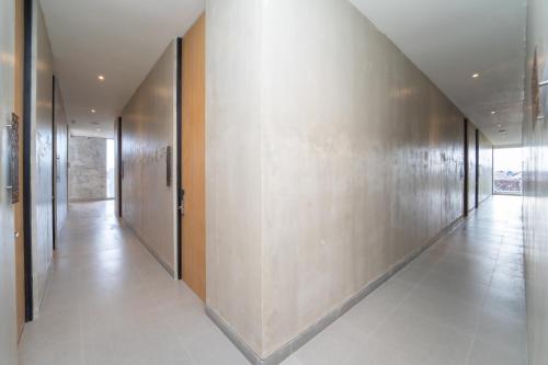 a hallway with a row of elevators in a building at Keenan Living Luxe Seturan in Seturan