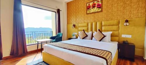 a hotel room with a bed and a large window at Orchard Green Dummi in Nāldera