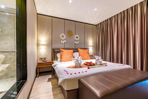 a bedroom with a large bed with orange pillows at BJ & Radisson Sea View Hotel in Ko Yao Yai