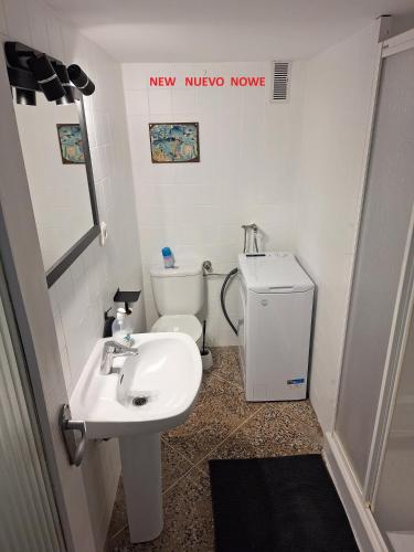 a bathroom with a sink and a toilet at Mar y castillo in Cullera