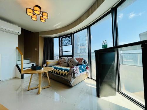 a living room with a couch and a table at Poly Central Plaza By Boli at Sanya City Center#Near Joy City in Sanya