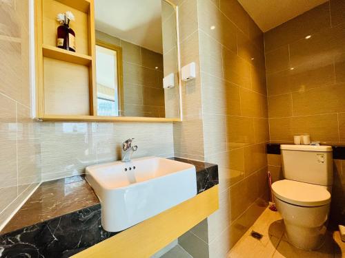 a bathroom with a sink and a toilet at Poly Central Plaza By Boli at Sanya City Center#Near Joy City in Sanya