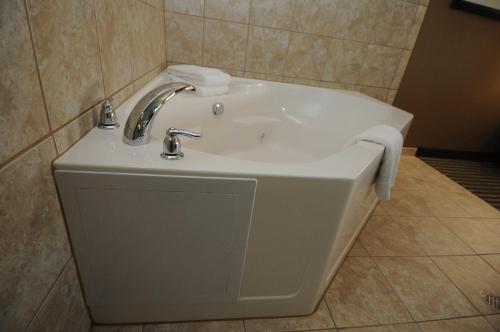a white sink in a bathroom with a tiled wall at Holiday Inn Express Somerset by IHG in Somerset