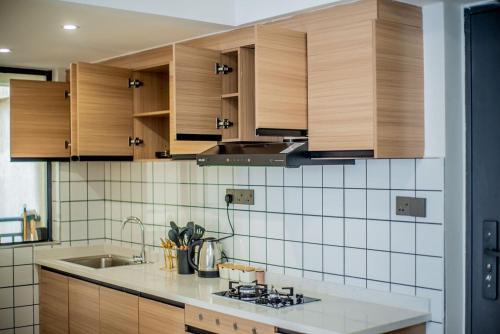 une cuisine avec des armoires en bois et un évier dans l'établissement New Dawn Home, à Ruaka