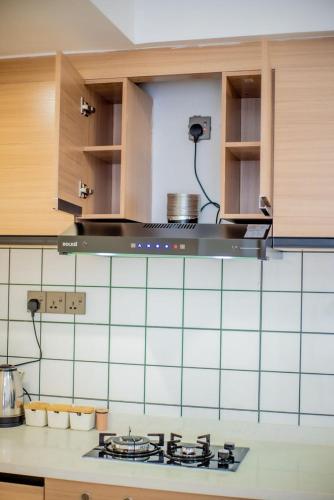 a kitchen with a stove top in a kitchen at New Dawn Home in Ruaka