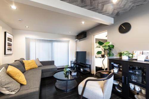 a living room with a couch and a table at BORO SAUNA Sapporo in Sapporo