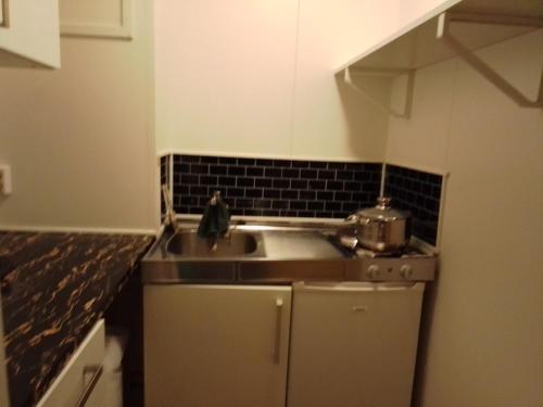 a kitchen with a sink and a counter top at Cozy room away from home in Åmot