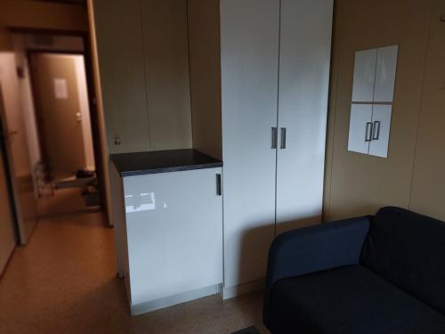 a living room with a couch and a white cabinet at Cozy room away from home in Åmot