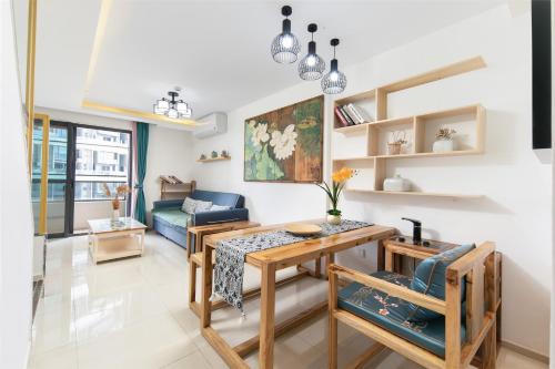 a living room with a table and a couch at Poly Central Plaza By Boli at Sanya City Center#Near Joy City in Sanya