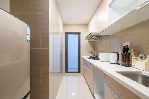a kitchen with a sink and a window at Poly Central Plaza By Boli at Sanya City Center#Near Joy City in Sanya