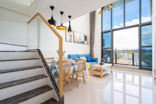a dining room and living room with a table and chairs at Poly Central Plaza By Boli at Sanya City Center#Near Joy City in Sanya