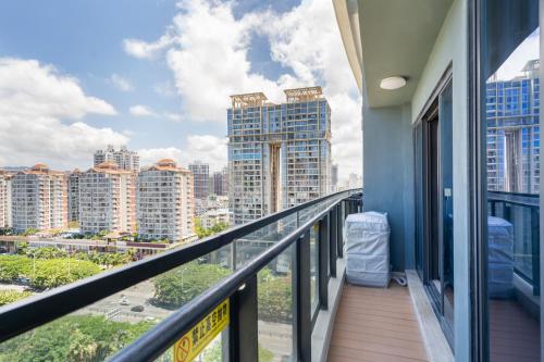 a balcony with a view of the city at Poly Central Plaza By Boli at Sanya City Center#Near Joy City in Sanya