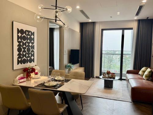 a living room with a dining table and a couch at Vinhomes Sky Park Bac Giang by QMP in Bắc Giang