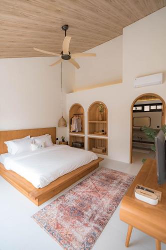 a bedroom with a bed and a wooden ceiling at The Cendana Villa Yogyakarta in Bedoyo
