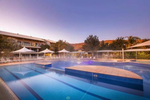 a large swimming pool in a resort at Crowne Plaza Alice Springs Lasseters by IHG in Alice Springs