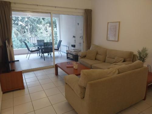 a living room with a couch and a table at Comfortable and Ideally Situated in Paphos City
