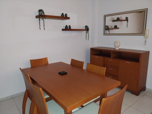 a dining room with a wooden table and a dresser at Comfortable and Ideally Situated in Paphos City