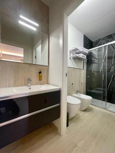 a bathroom with a sink and a toilet and a shower at VITA Residence in Castelvetro Piacentino