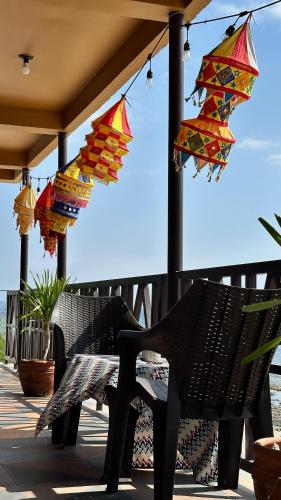 a group of umbrellas hanging from a porch at REEF HOUSE BACNOTAN White sand beach front with Private Swimming pool in Bacnotan