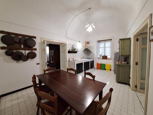 a kitchen with a wooden table and chairs in it at blue terrace Amalfi in Atrani