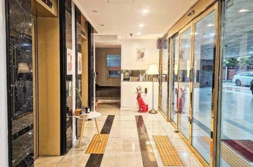 a hallway of a store with a woman in a red dress at Zara Hotel Peace Square in Mokpo