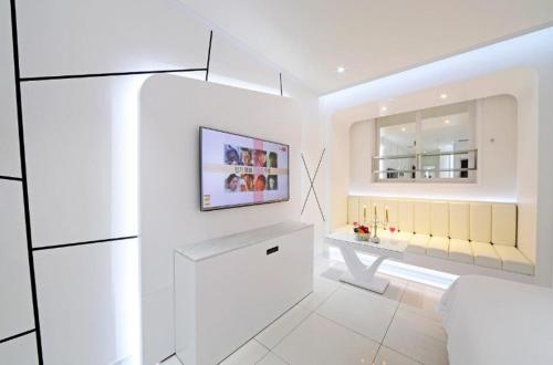 a white room with a table and a mirror at Zara Hotel Peace Square in Mokpo