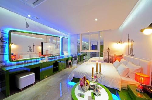 a bedroom with a bed and a large mirror at Zara Hotel Peace Square in Mokpo