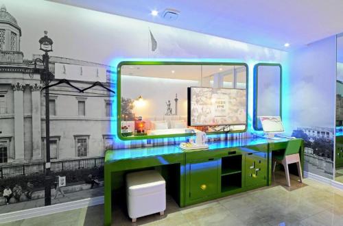 a room with a desk with a large window at Zara Hotel Peace Square in Mokpo