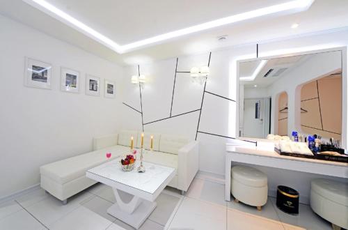 a white room with a table with candles on it at Zara Hotel Peace Square in Mokpo