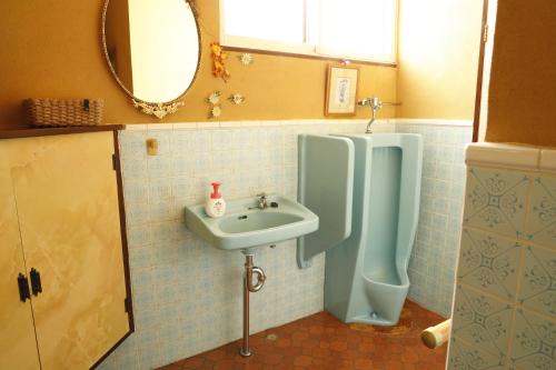 a bathroom with a sink and a urinal at つるのやど 