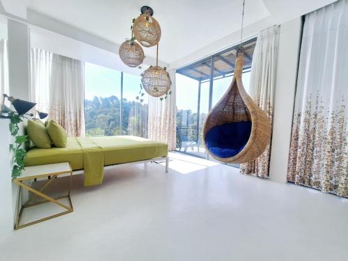 a living room with a couch and a hammock at X Mirissa in Mirissa