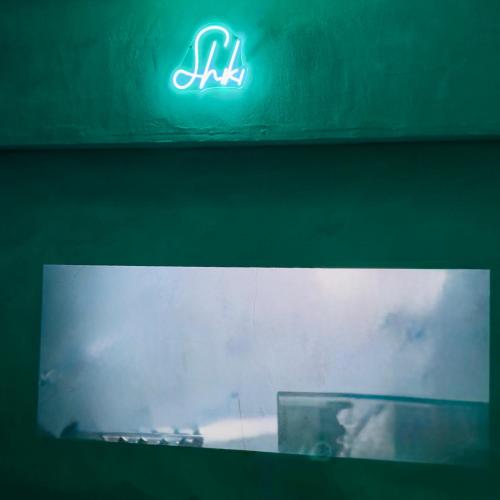 a lit up sign on top of a building at Shiki Villa Beppu in Beppu