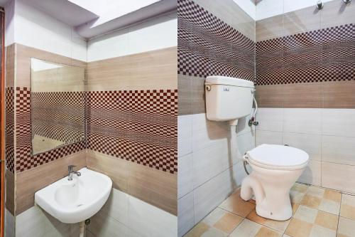 a bathroom with a toilet and a sink at Super Hotel O Tyagi Road near Railway Station in Dehradun
