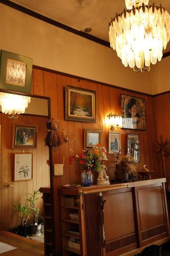 a room with wood paneled walls and a mirror at つるのやど 