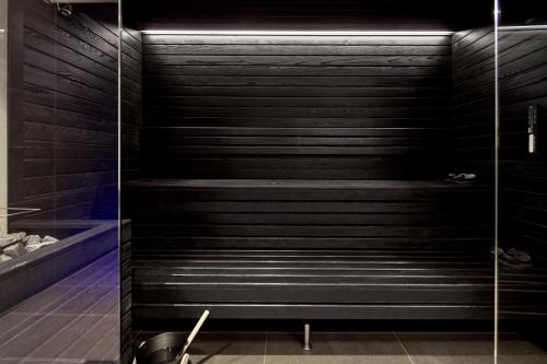 a walk in shower with black stairs in a bathroom at WANDERLUST HOTEL - SUITE & SPA - APARTMENTS & VILLAS - Bardolino, Lago di Garda - Verona in Bardolino