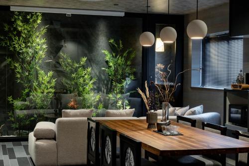 a living room with a table and some plants at JAPAVISTA Toan in Osaka