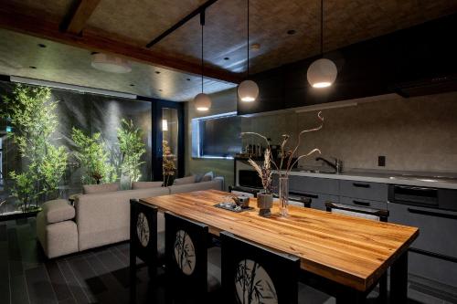 a kitchen with a wooden table in a room at JAPAVISTA Toan in Osaka