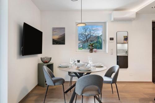 a dining room with a table and chairs at New Opening Vinea Guesthouse in Cornedo all'Isarco